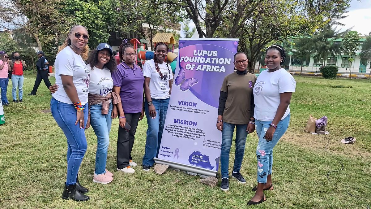 LFA members beside the Lupus Foundation of Africa banner