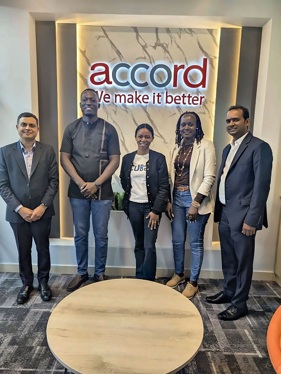 A meeting at Accord's offices, in front of the sign We make it better