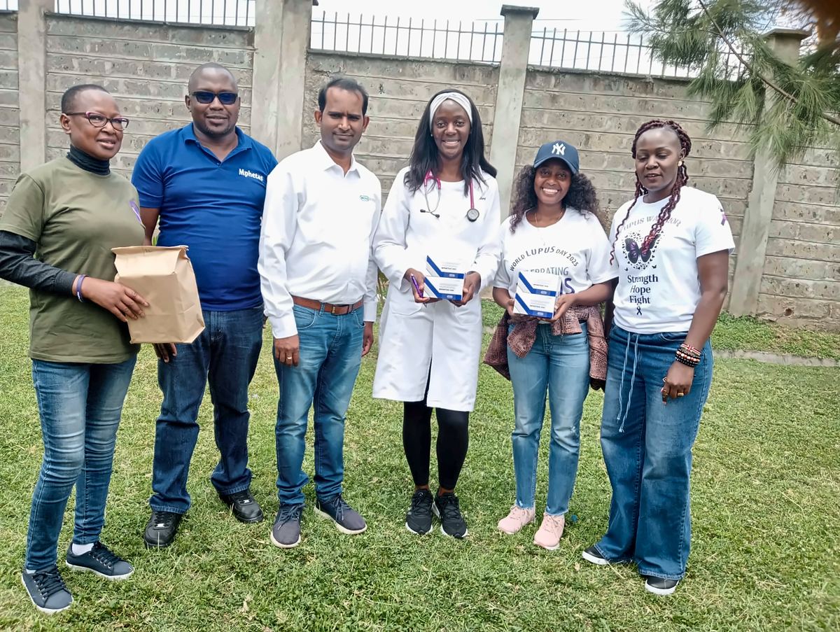 LFA members with a doctor and Mphetas and Intas representatives, holding boxes of Mphetas