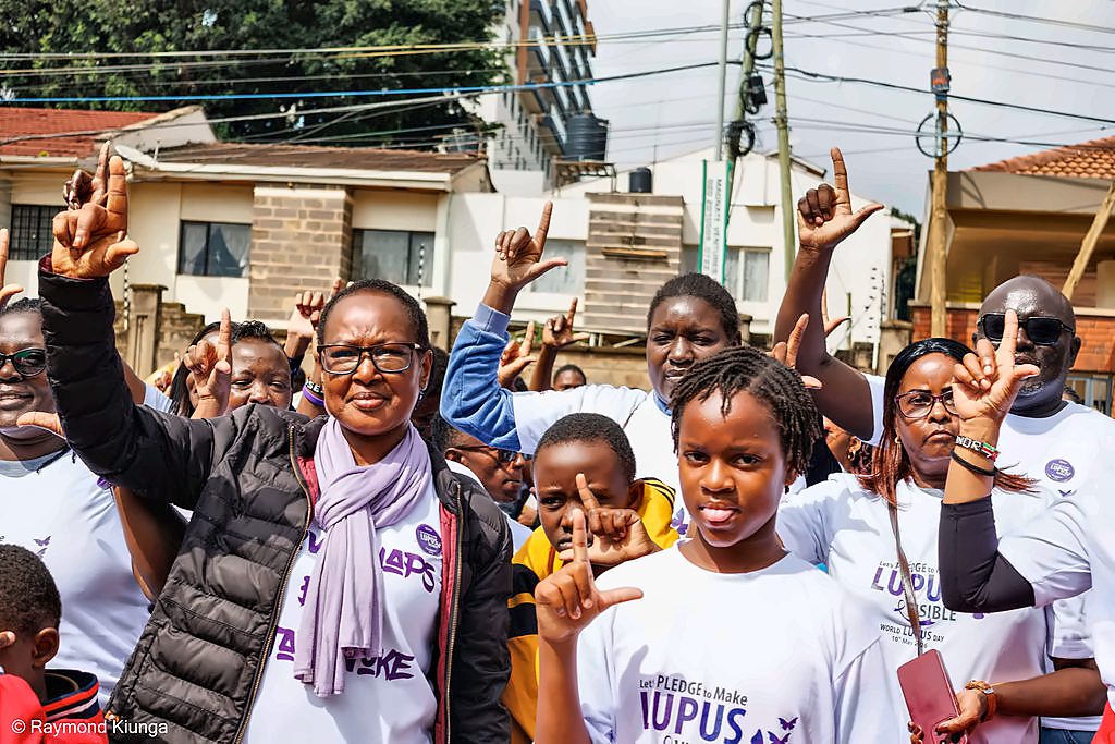 Members of the community cheering behind the banner