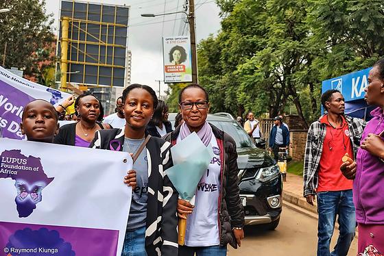 Walkers with the Lupus Foundation of Africa banner on a Nairobi street, World Lupus Day 2026